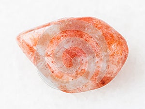 tumbled sunstone (heliolite) gemstone on white