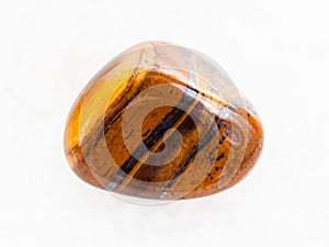 tumbled tigers eye gem stone on white