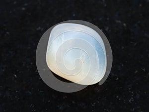 tumbled translucent moonstone gemstone on dark