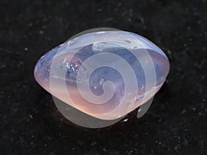 tumbled translucent moonstone gemstone on dark