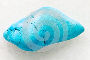 tumbled Turquenite (blue howlite) gem on white photo