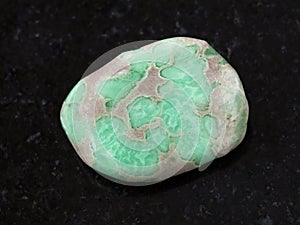 tumbled Variscite gemstone on dark background photo