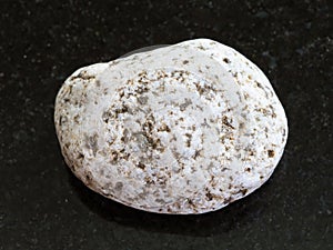 Tumbled of white Granite stone on dark background