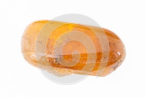 tumbled yellow garnet spessartine gem on white photo