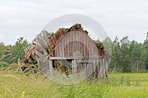 Tumbledown barn on a field