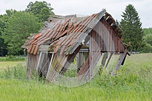 Tumbledown barn on a field