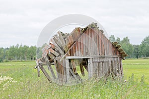 Tumbledown barn on a field