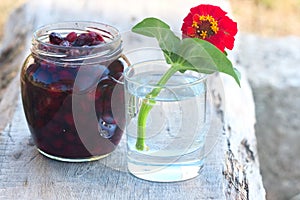 Tumbler with red flower and preserve