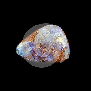 Tumbling opal stone on black background