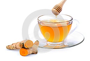 Cup of hot Turmeric tea with honey dipping .