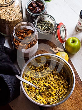 Tumeric bircher meusli being prepared on kitchen table in natural light