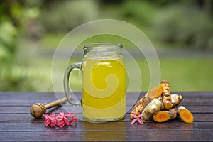 Tumeric ginger lemon drink in a jar