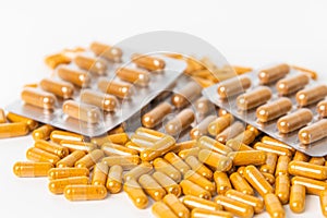 Tumeric powder capsules pill and blister packaging on white background