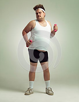Tummy in, bum out...an humorous overweight man lifting dumbbells.