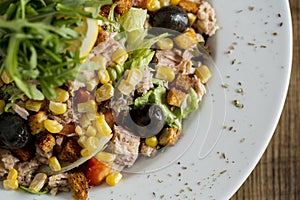 Tun salad with olives, corn and rocket