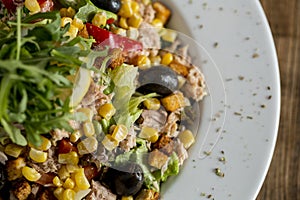 Tun salad with olives, corn and rocket