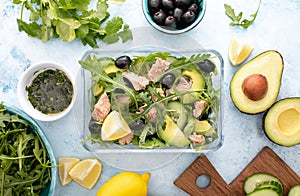 Tuna arugula salad prepared ahead and packed in a glass lunch box