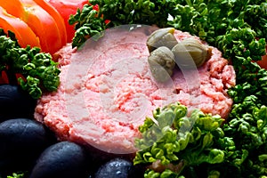 Tuna fish with black olives, tomatoes and parsley closeup