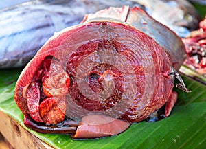 Tuna fish cut closeup photo. Fresh sea fish close-up. Tropical seaside fish market table. Tuna fish red meat slice