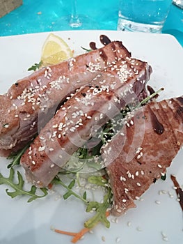 Tuna fish at the italian restaurant, plate of fish.