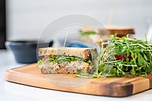 tuna mayo sandwich with mixed microgreen salad at side