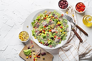 Healthy Green salad with tuna, corn, carrots, peas, pepper, beans and olives