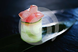 Tuna and philadelphia sushi roll on bamboo leaf