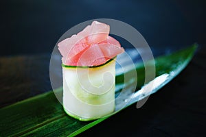 Tuna and philadelphia sushi roll on bamboo leaf