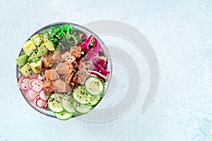 Tuna poke bowl with avocado, cucumbers, wakame, radish, and purple cabbage