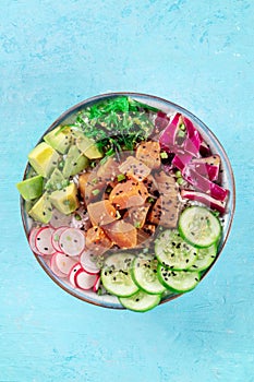 Tuna poke bowl with avocado, cucumbers, wakame, radish, and purple cabbage