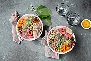 Tuna poke bowl with quinoa and vegetales. budda bowl. Quinua tuna salad on gray background photo