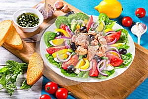 Tuna salad with anchovies, eggs, black olives, tomatoes, oil, basil, garlic, vinegar