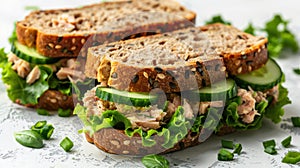 Tuna Salad Sandwich with Lettuce and Cucumbers on Multigrain Bread - Isolated on White