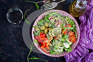 Tuna salad with tomatoes, olives, cucumber, sweet pepper and arugula