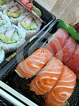 tuna, salmon sashimi, with sushi rolls,