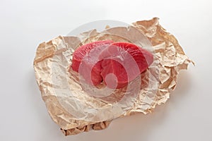 Tuna slices for steaks on white background. Two pieces of tuna on craft paper. Natural omega. Isolated object.