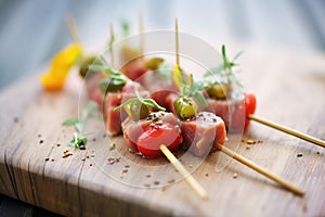 tuna steak bites on skewers with cherry tomatoes