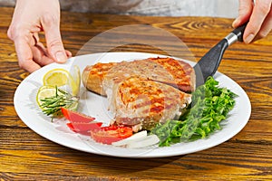 Tuna steak cooked on the electric grill. tunafish served on a plate with fresh herbs and vegetables. healthy nutritious