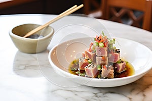 tuna steak cubes with dipping sauce in small bowl