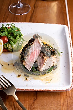 Tuna Steak Fillet with Spinach and Fresh Vegetables on a Table