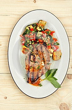 Tuna steak fried with grilled vegetables