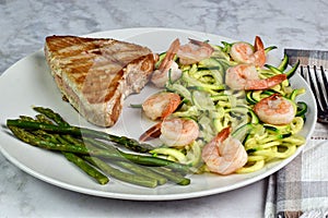 tuna steak served with zucchini noodle top with shrimp
