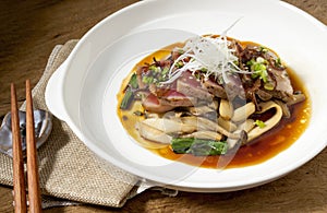 Tuniak v biely jedlo je umiestnené na drevený stôl japonec jedlo 