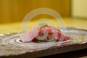 Tuna Sushi with fresh wasabi served on ceramic plate. Enjoy Omakase experience at Japanese Sushi Restaurant