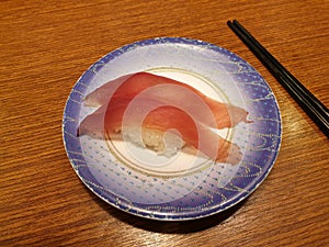 Tuna sushi on small plate. Popular conveyor belt sushi restaurant in Seoul.