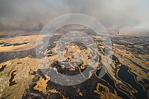 tundra fire. Burning dry grass and peat bogs, fire and smoke in
