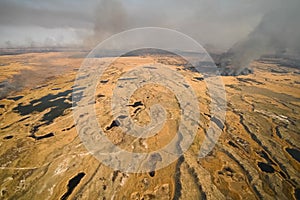 tundra fire. Burning dry grass and peat bogs, fire and smoke in photo