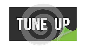 TUNE  UP text written on black green sticker