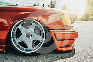 Tuned red sport car wheel, close up. Low rider sport auto