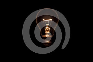 Tungsten light bulb on black background.